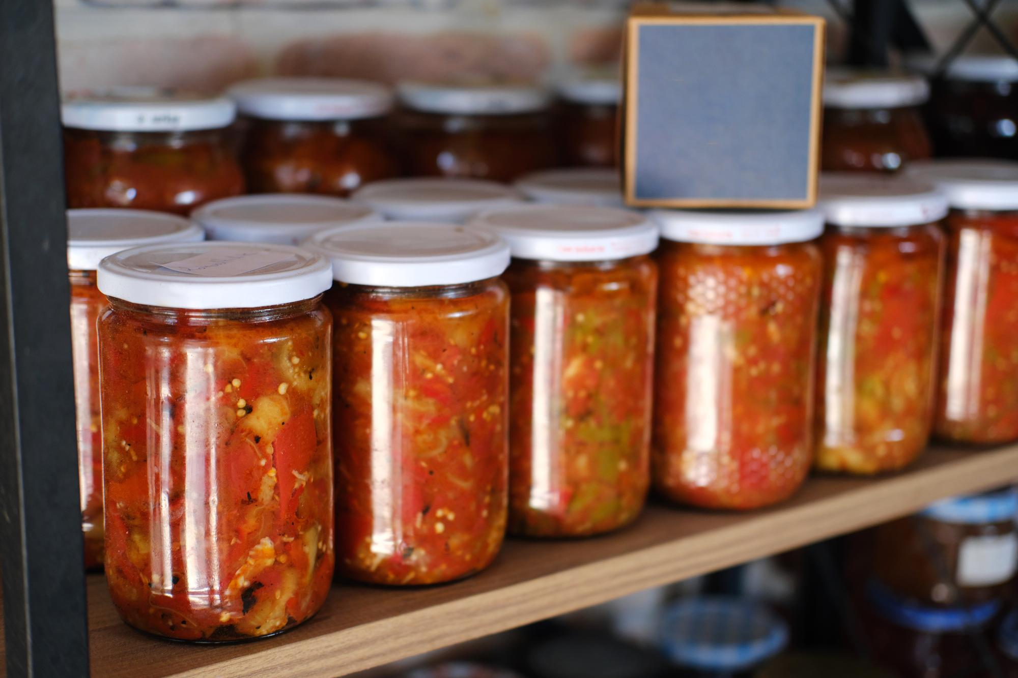 Set of packaged sauce jars on shelf